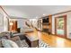 Spacious living room with hardwood floors, brick fireplace, comfortable seating, and access to outdoor space at 701 Bennington Dr, Raleigh, NC 27615