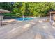 Community pool area with lounge chairs, lifeguard stand, and lush green surroundings at 701 Bennington Dr, Raleigh, NC 27615