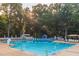 Large community swimming pool featuring lap lanes, a slide, and lounge seating areas at 701 Bennington Dr, Raleigh, NC 27615