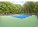 Well-maintained community tennis court with green and blue surface at 701 Bennington Dr, Raleigh, NC 27615