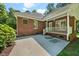 Back patio area with brick accents, offering a serene outdoor living space with a view of the surrounding greenery at 745 Oaks Lane Rd, Timberlake, NC 27583
