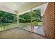 Covered back patio with white columns and railings, offering a shaded outdoor space with a view of the backyard at 745 Oaks Lane Rd, Timberlake, NC 27583