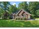 Attractive red brick home boasts a verdant lawn, tidy landscaping, and an attached two-car garage at 745 Oaks Lane Rd, Timberlake, NC 27583