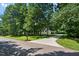 Charming brick home featuring a long driveway and surrounded by mature trees at 745 Oaks Lane Rd, Timberlake, NC 27583
