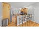 Open kitchen with wood cabinets, stainless appliances, breakfast bar, and view to Gathering room at 745 Oaks Lane Rd, Timberlake, NC 27583