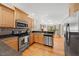 Kitchen with wood cabinets, stainless steel appliances, and view into dining area at 745 Oaks Lane Rd, Timberlake, NC 27583