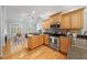 Open kitchen with wood cabinets and stainless steel appliances with view to living room at 745 Oaks Lane Rd, Timberlake, NC 27583