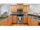 Close up of kitchen showing wood cabinets, stainless steel appliances, and tile backsplash at 745 Oaks Lane Rd, Timberlake, NC 27583