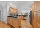 Open kitchen with wood cabinets, stainless steel appliances, and hardwood floors at 745 Oaks Lane Rd, Timberlake, NC 27583