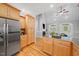 Kitchen with wood cabinets and stainless steel appliances, adjacent to living area with fireplace at 745 Oaks Lane Rd, Timberlake, NC 27583