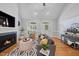 Bright living room featuring a fireplace, hardwood floors, and large arched windows at 745 Oaks Lane Rd, Timberlake, NC 27583