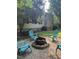 Backyard with fire pit area and Adirondack chairs, perfect for outdoor relaxation at 7801 Kingsbrook Ct, Wake Forest, NC 27587