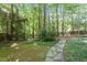 Lush backyard with stone pathway, offering a peaceful outdoor escape at 7801 Kingsbrook Ct, Wake Forest, NC 27587