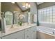 Bright bathroom with dual sinks, soaking tub, and large windows for ample natural light at 7801 Kingsbrook Ct, Wake Forest, NC 27587