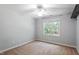 Neat bedroom with neutral walls, soft carpet, ceiling fan and bright natural lighting at 7801 Kingsbrook Ct, Wake Forest, NC 27587