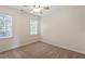 Cozy bedroom with neutral carpeting, ceiling fan, and natural light at 7801 Kingsbrook Ct, Wake Forest, NC 27587