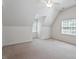 Large bedroom with dormer windows, neutral carpet, and bright natural light at 7801 Kingsbrook Ct, Wake Forest, NC 27587
