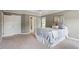 Relaxing bedroom with neutral walls, carpet, and natural light from windows and ensuite door at 7801 Kingsbrook Ct, Wake Forest, NC 27587