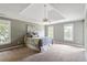 Comfortable carpeted bedroom with a ceiling fan and plenty of natural light from the windows at 7801 Kingsbrook Ct, Wake Forest, NC 27587
