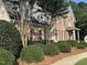 A charming brick two-story home with detailed landscaping and a welcoming front porch at 7801 Kingsbrook Ct, Wake Forest, NC 27587