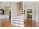 Bright foyer with hardwood floors, staircase, and views into other rooms at 7801 Kingsbrook Ct, Wake Forest, NC 27587