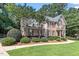 Charming brick home with a well-manicured lawn and mature trees at 7801 Kingsbrook Ct, Wake Forest, NC 27587