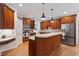 Open kitchen featuring an island, stainless steel appliances, and custom cabinetry at 7801 Kingsbrook Ct, Wake Forest, NC 27587