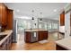 Open kitchen with island, stainless steel appliances, and hardwood floors at 7801 Kingsbrook Ct, Wake Forest, NC 27587