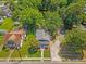 Charming home with a welcoming front porch and well-manicured lawn, surrounded by lush greenery at 813 N Main St, Burlington, NC 27217