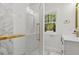 Modern bathroom featuring glass-enclosed shower and window at 813 N Main St, Burlington, NC 27217