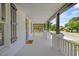 A comfortable and spacious front porch with stylish pillars and railings at 813 N Main St, Burlington, NC 27217