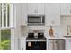 Bright kitchen featuring stainless steel appliances, updated countertops, and lots of cabinet space at 813 N Main St, Burlington, NC 27217