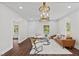 A sunlit living room featuring a neutral color palette and hardwood floors at 813 N Main St, Burlington, NC 27217