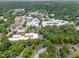 Aerial view of a community showcasing lush greenery, neighborhood streets, and various building structures at 815 Daniels St # A, Raleigh, NC 27605