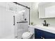 Modern bathroom featuring a glass-enclosed shower, stylish vanity, and sleek black fixtures at 815 Daniels St # A, Raleigh, NC 27605