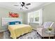 Cozy bedroom with a ceiling fan, large window, and a comfortable armchair at 815 Daniels St # A, Raleigh, NC 27605