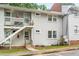 Apartment building with white siding and staircases leading to upper-level units at 815 Daniels St # A, Raleigh, NC 27605