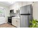 Modern kitchen with stainless steel appliances, white cabinets, and ample countertop space at 815 Daniels St # A, Raleigh, NC 27605
