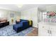 Comfortable living room features a blue sectional sofa, decorative rug, and a wall-mounted television at 815 Daniels St # A, Raleigh, NC 27605