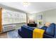 Inviting living room with bright windows, a comfortable blue sectional sofa, and modern decor at 815 Daniels St # A, Raleigh, NC 27605