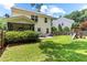 A backyard view of the house that includes a covered patio with an outdoor dining set and a playset at 822 Blue Lake Dr, Mebane, NC 27302