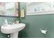 Stylish half bath with a modern sink, decorative mirror, and a fresh, clean aesthetic at 822 Blue Lake Dr, Mebane, NC 27302