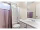 Functional bathroom with a shower-tub combo, complemented by a clean white vanity and ample natural light at 822 Blue Lake Dr, Mebane, NC 27302