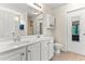 Bright bathroom featuring double sinks, a large mirror, and neutral tile flooring and ample vanity storage at 822 Blue Lake Dr, Mebane, NC 27302