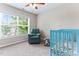 Comfortable Bedroom with a cozy recliner, a charming crib, and a large window offering plenty of natural light at 822 Blue Lake Dr, Mebane, NC 27302