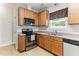 Efficient kitchen layout with stainless steel appliances, wood cabinets, and durable countertops at 822 Blue Lake Dr, Mebane, NC 27302