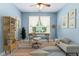 Bright office space featuring a ceiling fan, large window, modern desk, and stylish shelving for an inspiring work environment at 822 Blue Lake Dr, Mebane, NC 27302