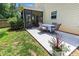 A stone patio with an outdoor dining table and a covered porch at 822 Blue Lake Dr, Mebane, NC 27302