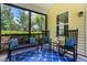 The porch includes a bench, chairs and plants at 822 Blue Lake Dr, Mebane, NC 27302