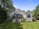 Expansive backyard with an outdoor patio, beautiful landscaping, and large grassy area at 8416 Davishire Dr, Raleigh, NC 27615